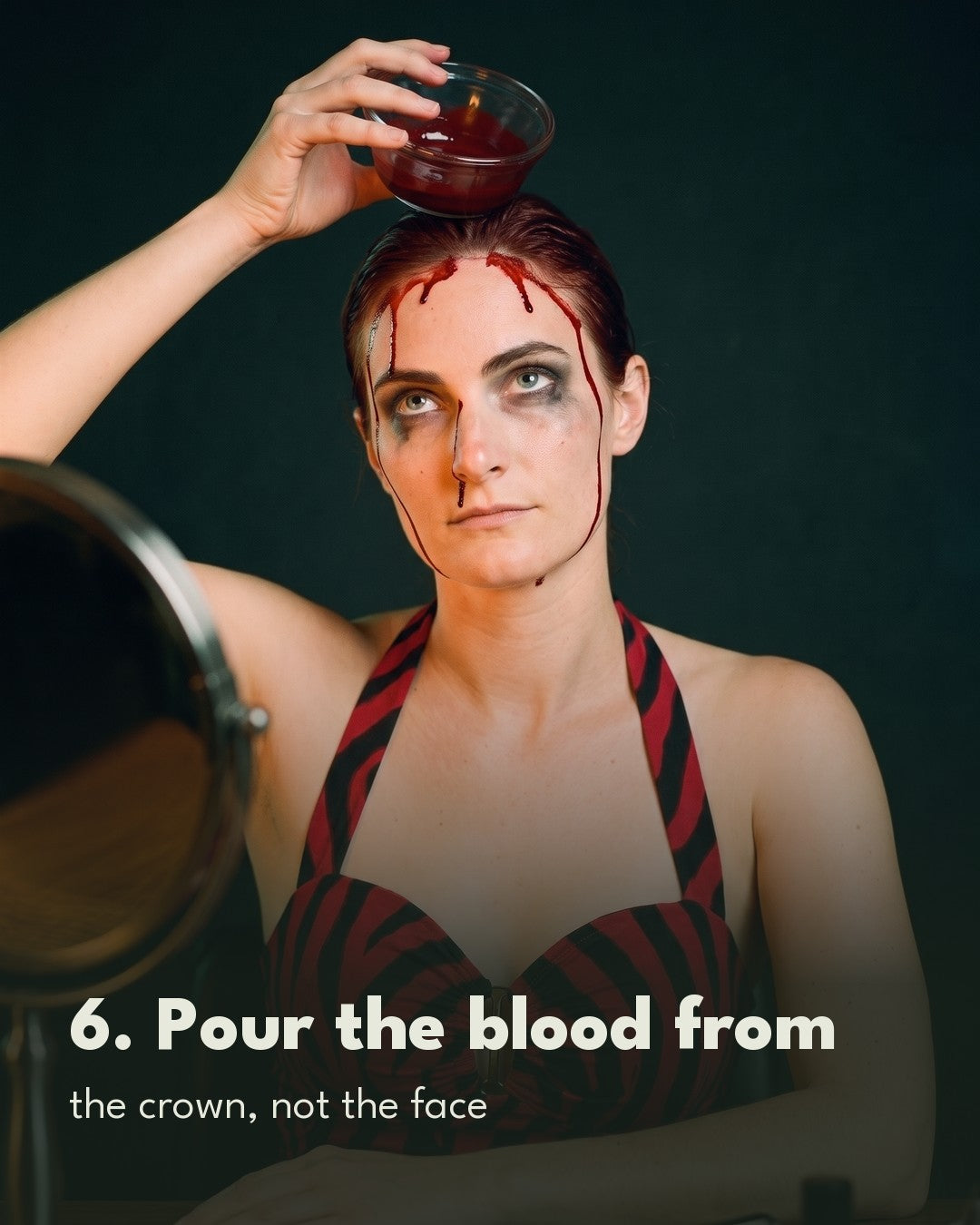 Nikki party look makeup tutorial: pouring fake blood from a bowl over the crown of the head so it runs down the forehead and face