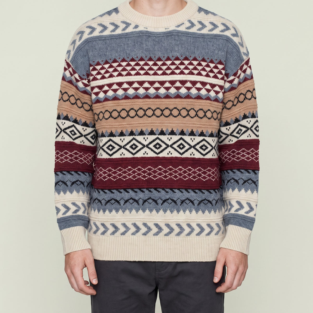 Man wearing Bear's fair isle jacquard knit sweater, cropped below the chin, red colorway