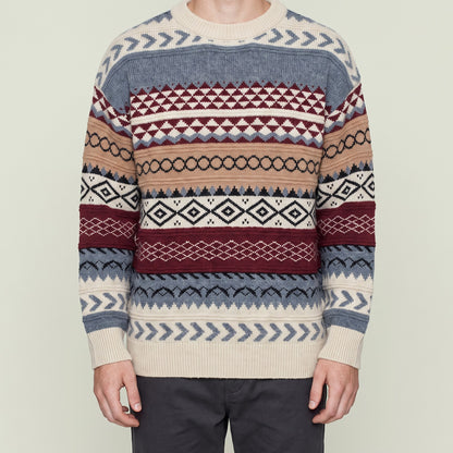 Man wearing Bear's fair isle jacquard knit sweater, cropped below the chin, red colorway