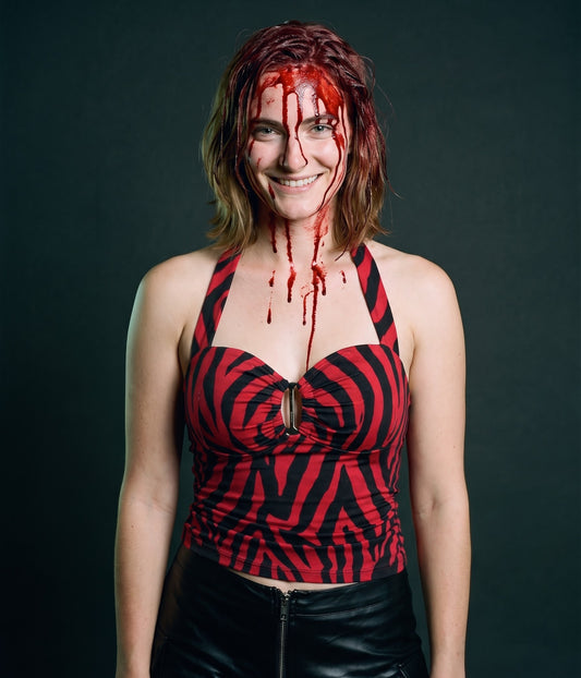 Nikki party look costume from Obsession: red and black zebra halter top and black faux leather shorts, worn with fake blood makeup